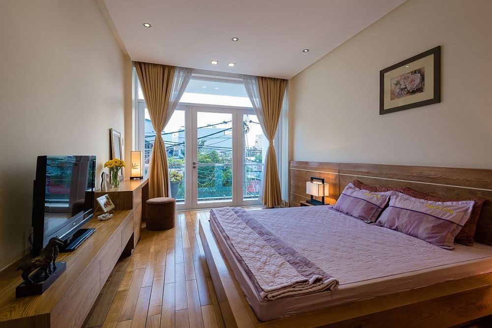 Description: Wooden bed and headboard in the modern bedroom feel like an extension of the floor Nhà phố Sài Gòn với thiết kế giải quyết vấn đề về diện tích qpdesign